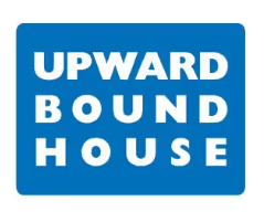 A blue rectangular sign with the words UPWARD BOUND HOUSE in bold, white capital letters, arranged in three rows.