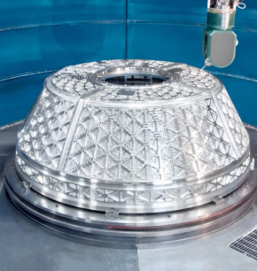 A robotic arm inspects a large, conical Engineered Components Company spacecraft part featuring an internal lattice structure.